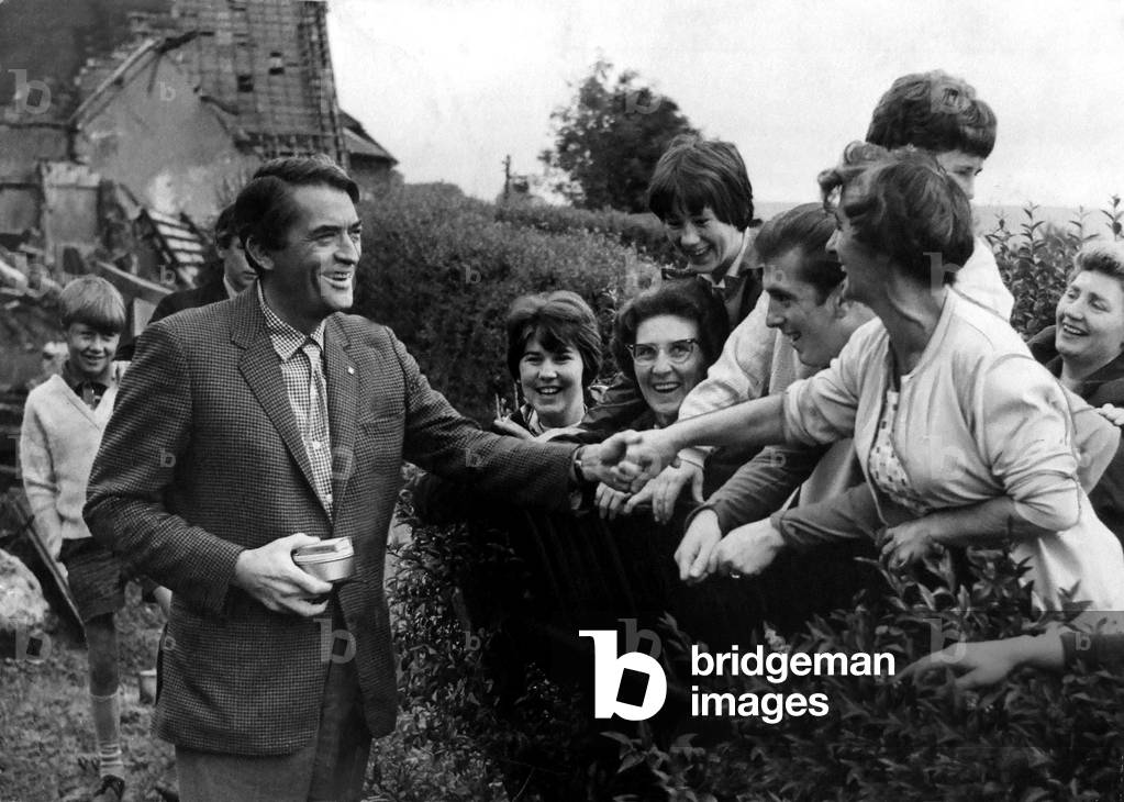 Hollywood filmstar Gregory Peck shakes hands with delighted residents of Crumlin on his arrival on the set where he his shooting scenes for the film 'Arabesque' - 22nd August 1965