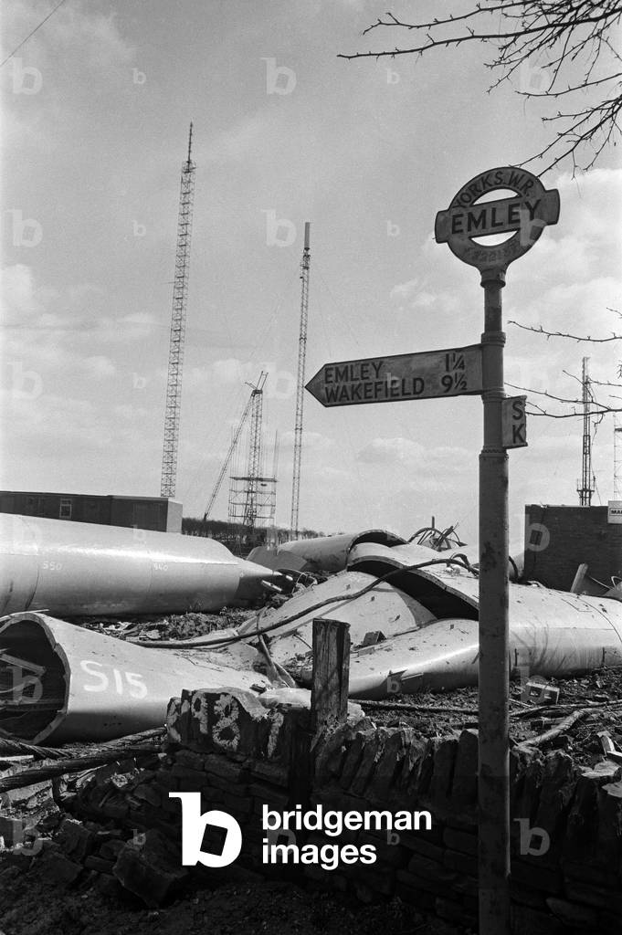 The collapsed Emley Moor transmitting station mast lies on the ground as engineers put the finishing touches to the BBC Two mast which towers 307ft off the ground. 16th April 1969 (b/w photo)