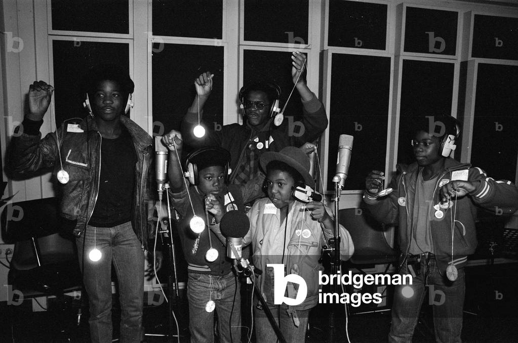 Musical Youth, British Jamaican pop / reggae group, at Capital Radio studios in London where they are helping to launch a road safety campaign involving glitter discs 8th October 1982 (b/w photo)