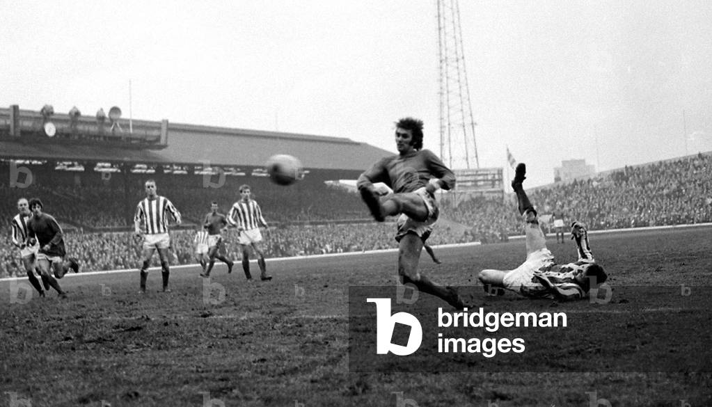 Sunderland full back Harvey hits the mud trying to stop Manchester United star George Best who manages to get a shot in on goal during their league match at Roker ParkNovember 1968 (photo)