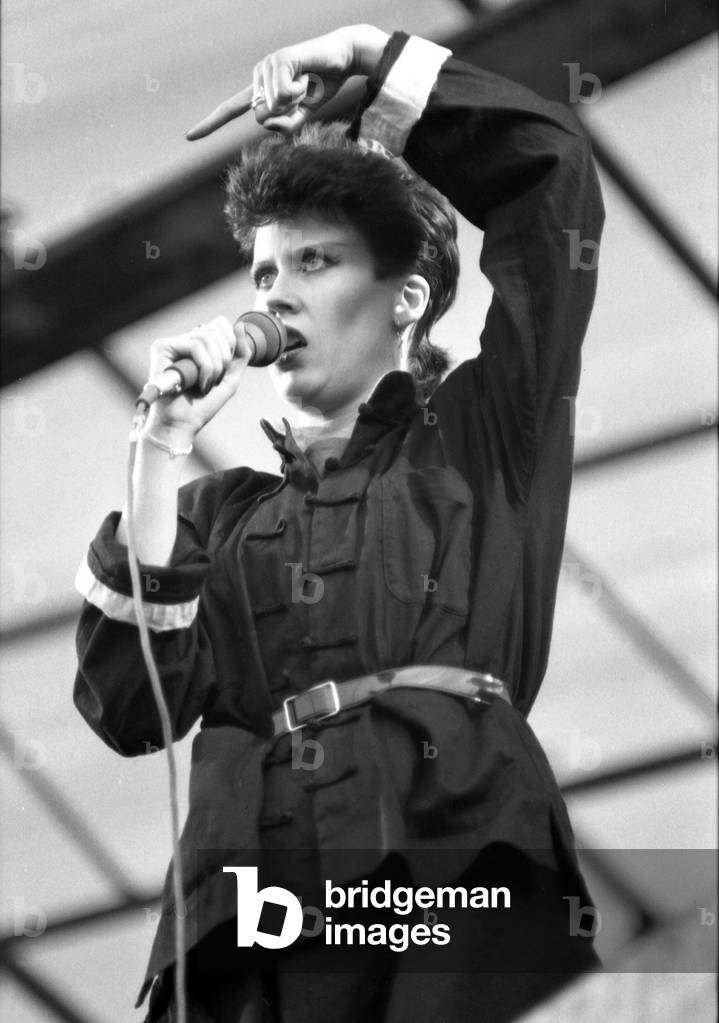 Hazel O'Connor performs on stage at the outdoor concert in aid of racial harmony at The Butts stadium in Coventry, 22nd June 1981 (b/w photo)