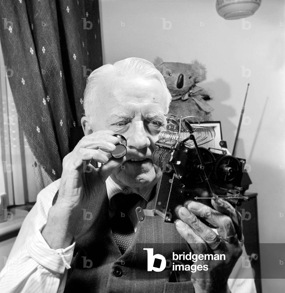 Timelord: Clock repairer Bill Marshall seen here repairing the movement to a mantle clock. 1960