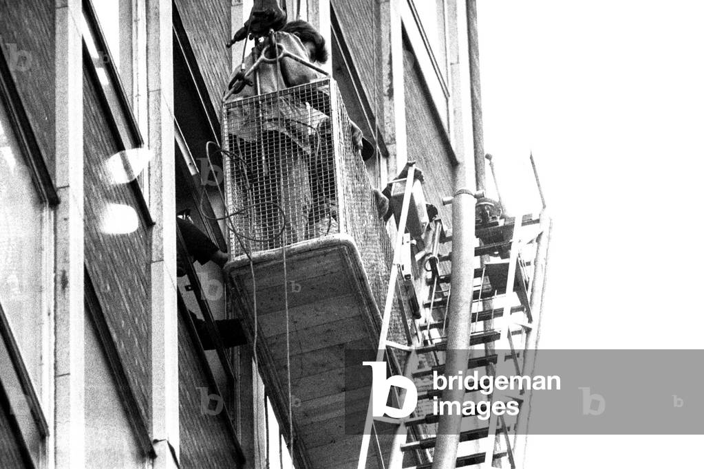 Window cleaners Richard Pendleton and John McKenzie were trapped for 20 minutes after their cradle broke down on the Gallowgate side of the Scottish and Newcastle Breweries building, 21st April 1970 (b/w photo)