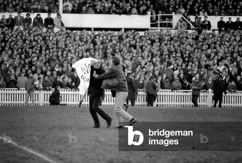 Sport Rugby Union. East Midlands v South Africa. Demonstration against the Springbok visit and apartheid policy. A demonstrator is escorted from the pitch by Police stewards. November 1969