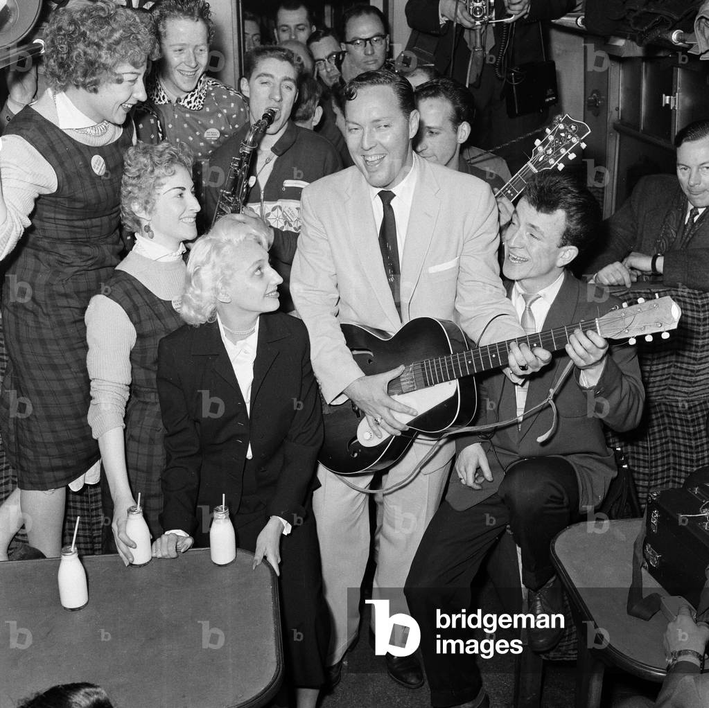 Frenzied scenes as American rock and roll singer Bill Haley arrives in London. 5th February 1957 (b/w photo)