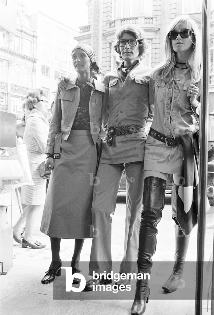 Yves Saint Laurent, designer pictured outside his first London Rive Gauche store on New Bond Street, London, opening day of boutique, and with muses Louise de La Falaise, aka Loulou (left) and Betty Catroux (right). 10th September 1969 (b/w photo)