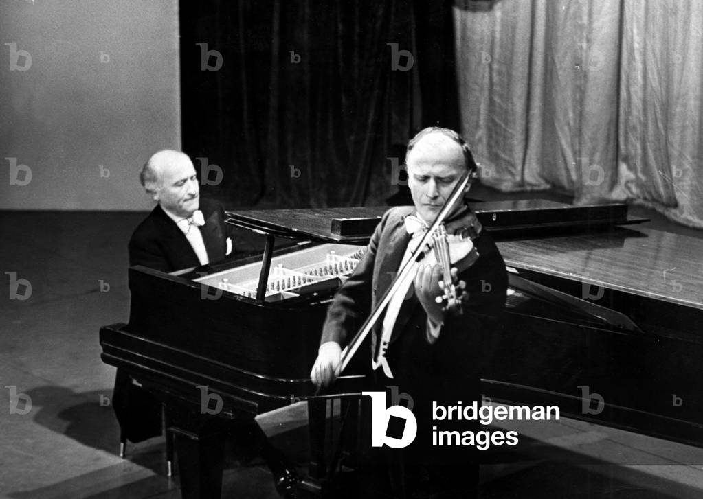 Yehudi Menuhin - Famous concert violinist pictured at Llandaff Cathedral, Cardiff, where he performed with the Bath Festival Chamber Orchestra. Behind him is Epstein's Christ in Majesty, 20th June 1964 (b/w photo)
