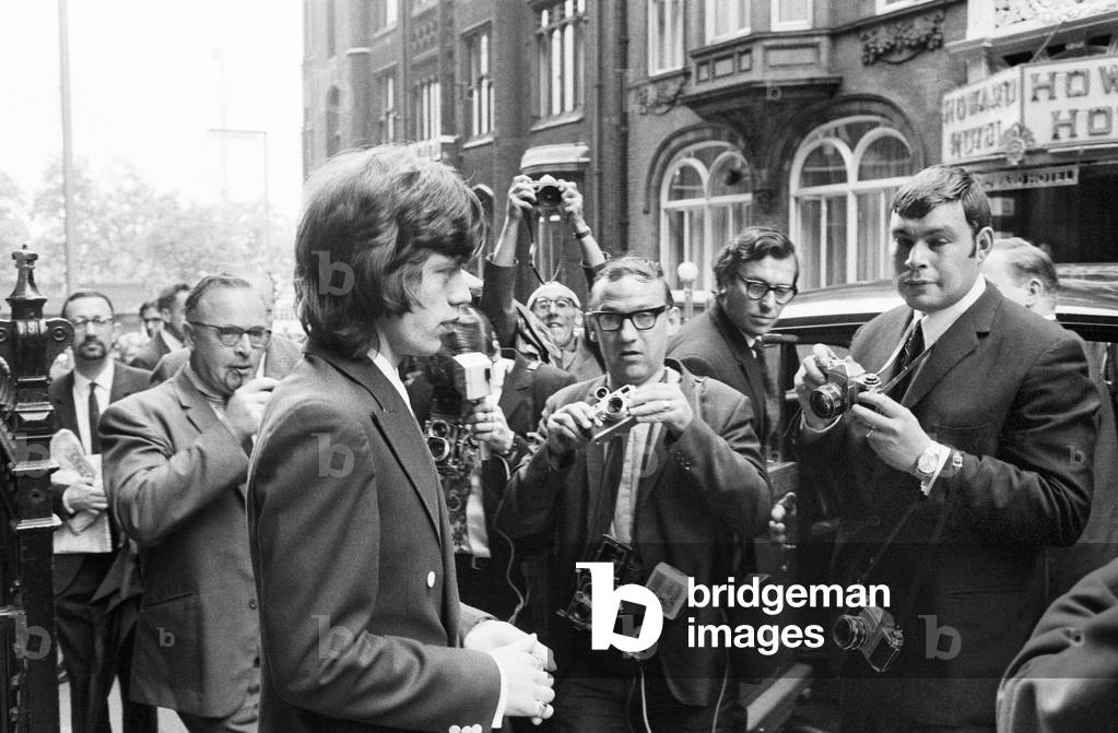 Appeal hearing at the Appeal Court in Central London where Rolling Stones lead singer Mick Jagger and Keith Richards had their convictions and sentence for drug charges set aside by Lord Parker the Lord Chief Justice, Lord Justice Winn and Mr Justice Cusack. Pictured: Mick Jagger leaving the solicitors office at Lennox House in Howard Street before the hearing. Jagger was given a conditional discharge and talking to in place of his three month prison sentence and Keith Richards conviction was quashed on legal grounds. 31st July 1967 (b/w photo)