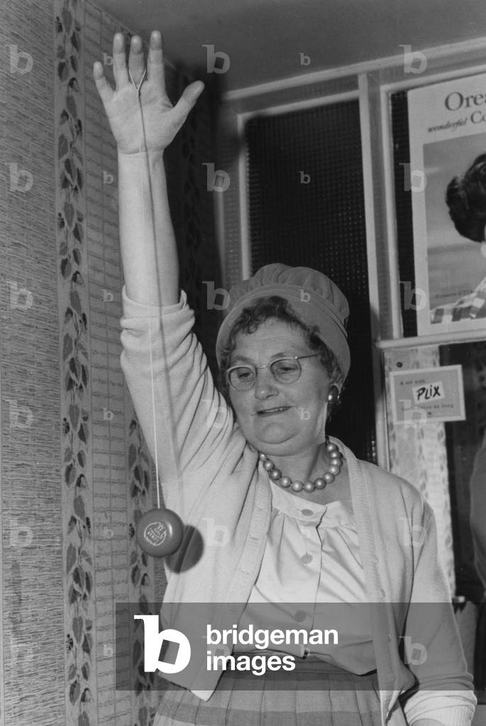 Elderly woman seen here playing with a yo-yo. 6th December 1961