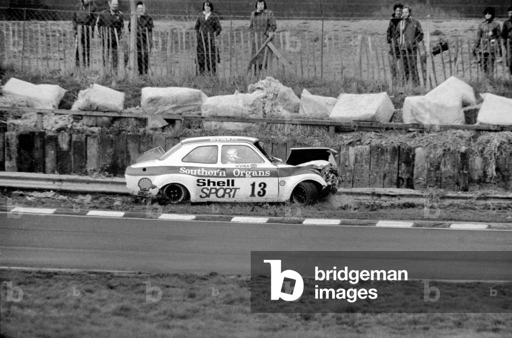 Britains ex-ski champion Divina Galica crashed her £6000 car on the second lap of her very first professional race at Brands Hatch today, 2nd February 1975 (b/w photo)