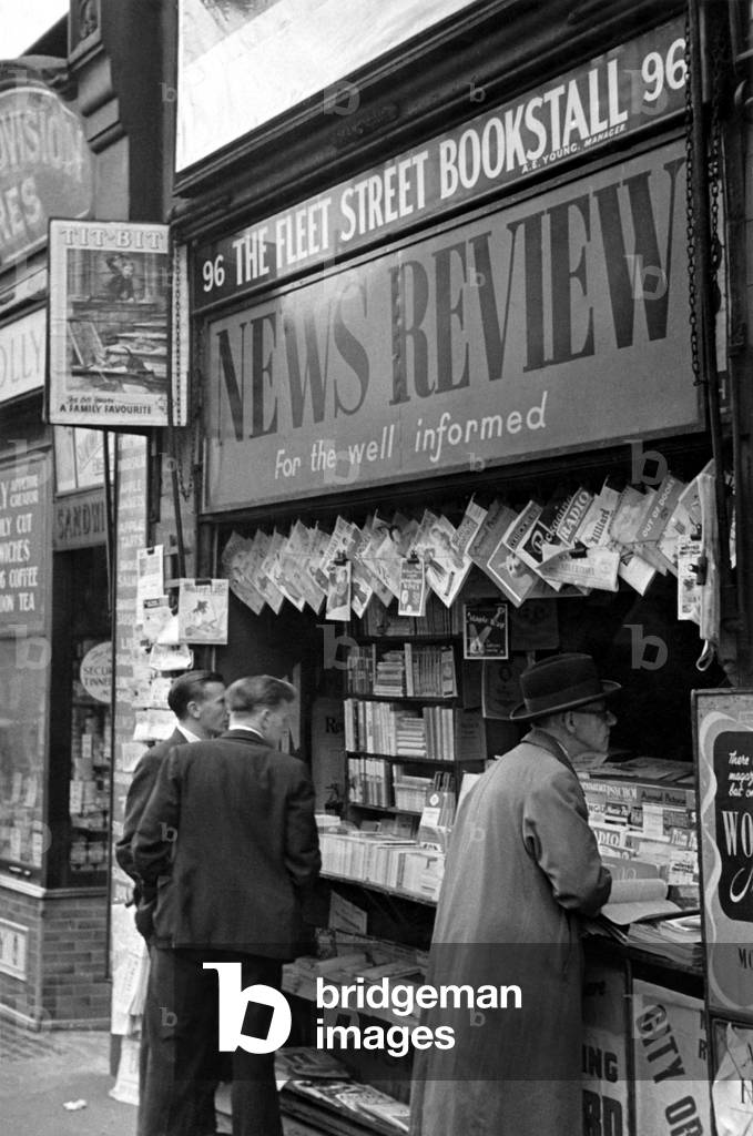 A newspaper vendor, c.1950 (b/w photo)