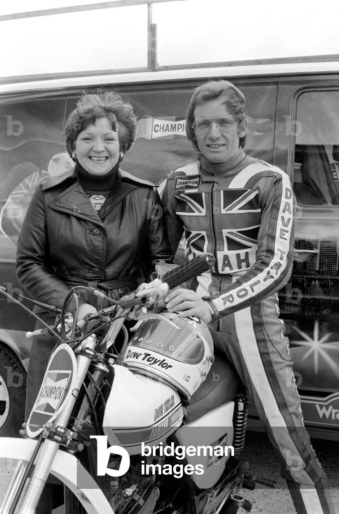 Motorbike stunt: Dave Taylor performing a tank stand at 90 M.P.H, April 1977 (b/w photo)