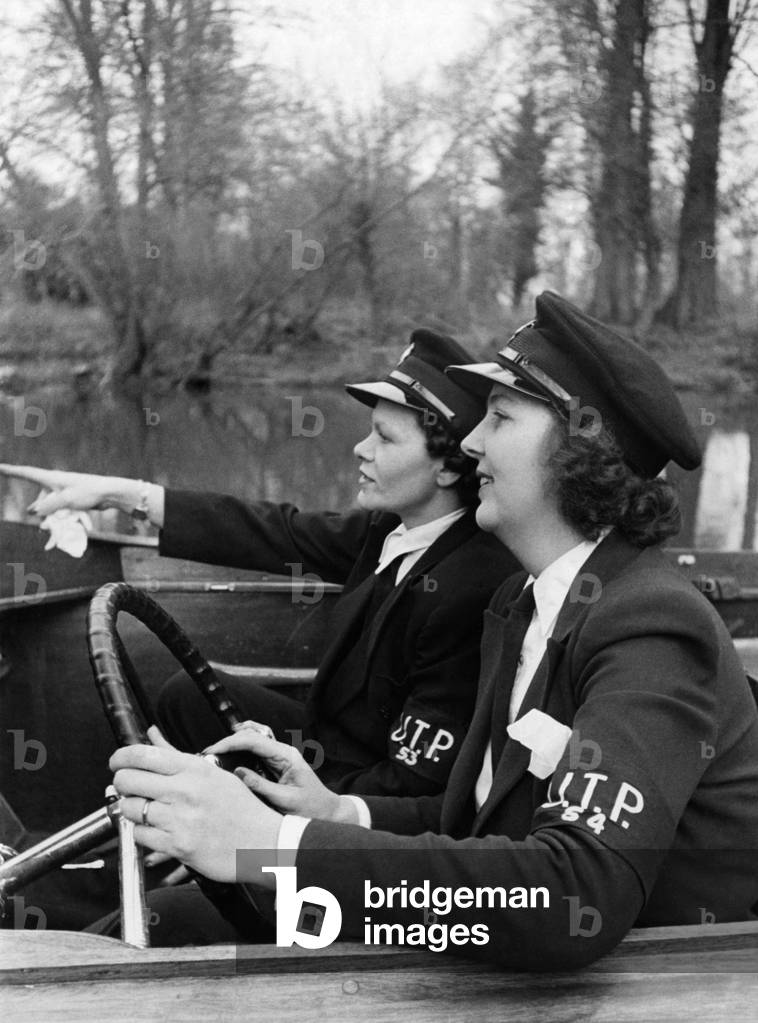 Mrs. W C Thiele (right) and Mrs. P Bartlett who are the helmsmen of patrol launches of the upper Thames Patrol (Home Guard). Pictures taken at maidenhead where they have been on active service since the inception of the UTP January 1941