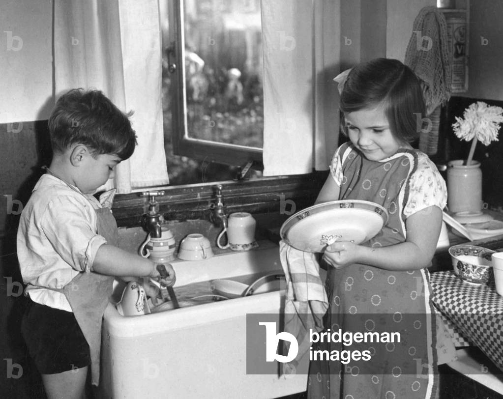 Two children washing up. c. 1945