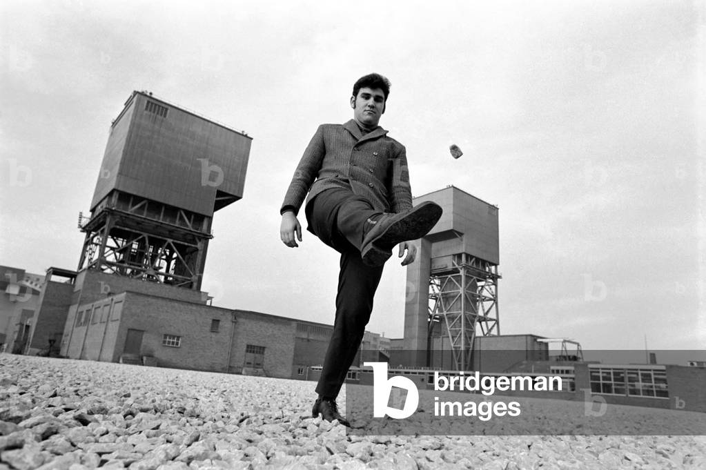 A coal miner before the huge Bevercotes Colliery. Time office of the pit. December 1969 Z11710