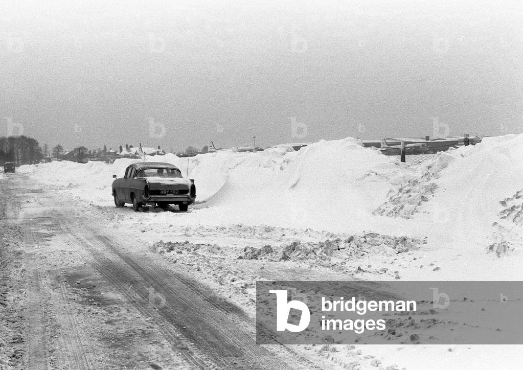 A snowy road next to Coventry airport, Baginton, Coventry. 3rd January 1963 (b/w photo)