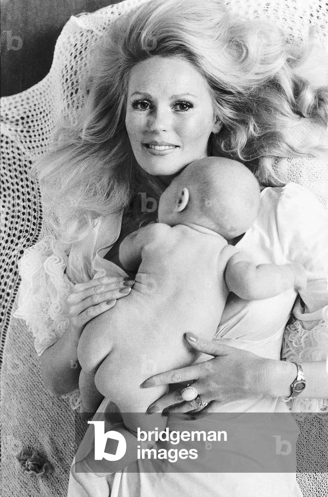 Actress Veronica Carlson holding her new baby Carly, 22nd October 1976 (b/w photo)