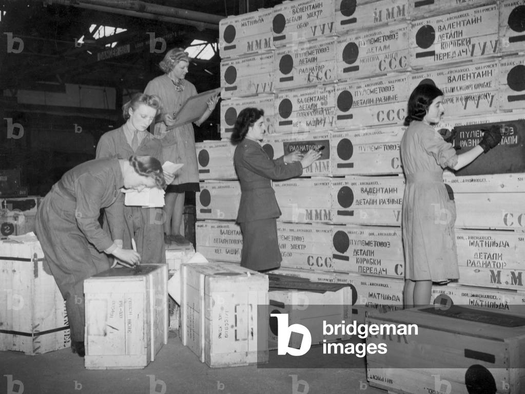 Arms for Russia. Girls at the Ordinance factory stencilling suupplies for the USSR with Russian words, 20th April 1942 (b/w photo)