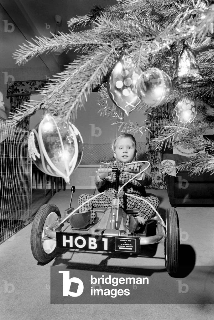 David Smith, a bright three year old from Pattingham, Staffordshire as you can see Santa arrived early this year for David bring a shining new Go Kart. However it is no ordinary Kart but Davids only method of transport for he is a victim of Spina Bifida and has no real use in his legs. The Kart has been specially designed and made by apprentices at a large Wolverhampton, Engineering Factory and was presented to David this week. The Kart which is used by David inside and outside his home is even fitted with a reverse gear. Now Home Office Officials are interested in producing the Kart in Prisons and Borstal Institution and it should sell for approximately £20. December 1969