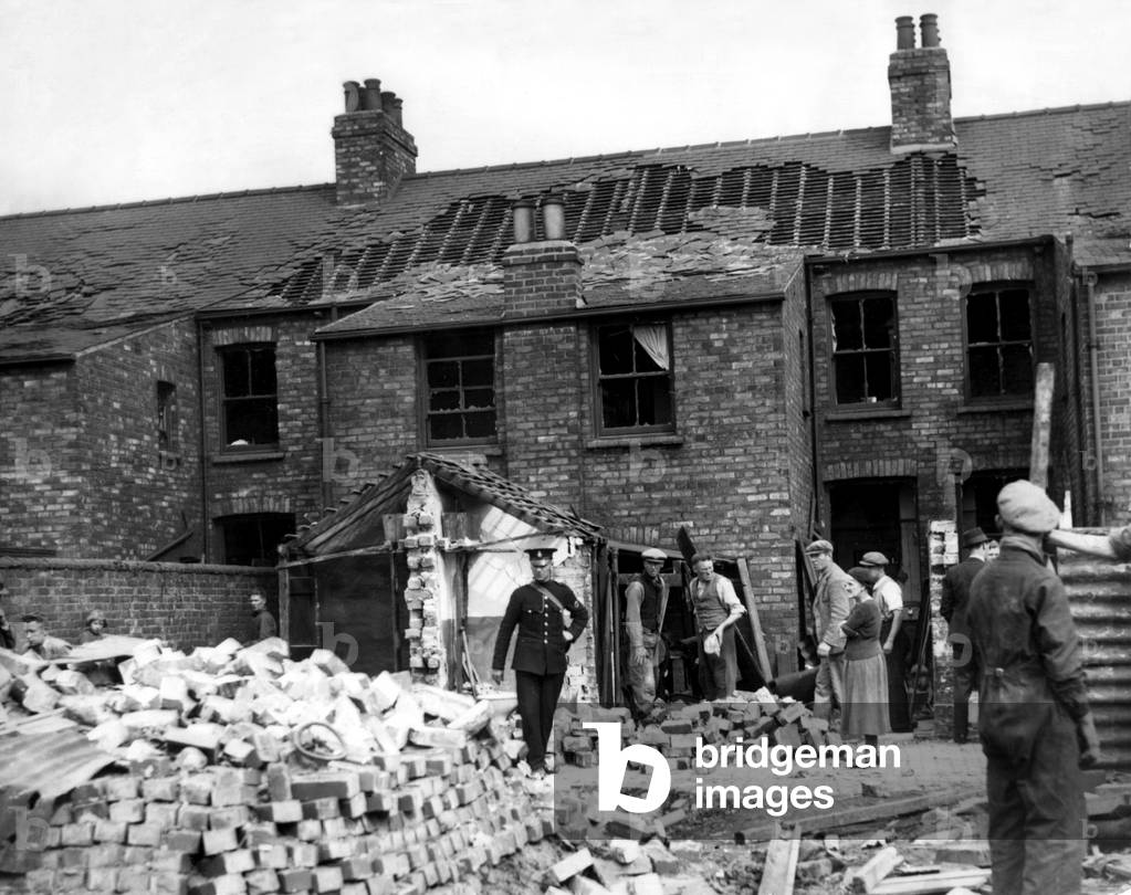 Second World War - Workmen deal with the results of a German air raid on a town in the North Riding of Yorkshire. 25/05/1940 (b/w photo)