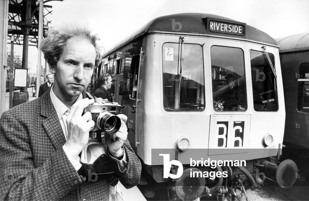 Mr. Graham Hague from Sheffield who is a railway enthusiast taking pictures of a Diesel Multiple Unit on 21st July 1973 (b/w photo)