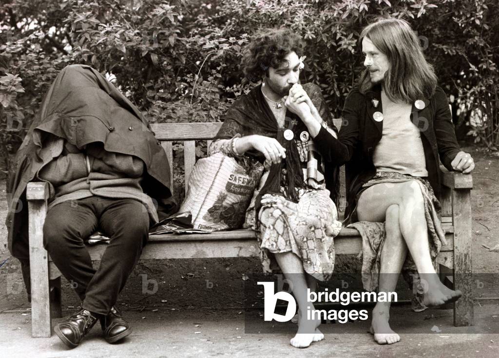 Men dressed as women sitting on a park bench as they take a break from the gay pride march at Hyde Park
June 1977