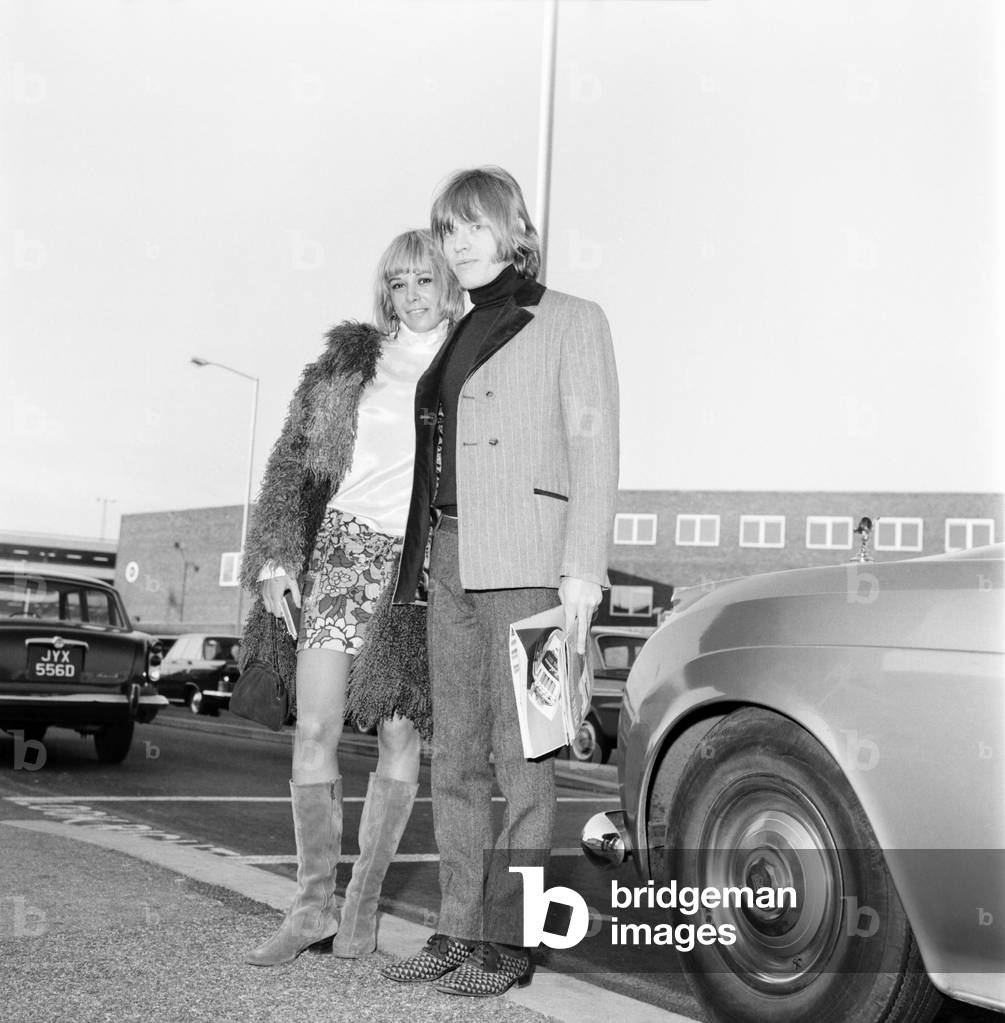 Brian Jones of the Rolling Stones melt his girl friend Anita Pallenberg as she arrived at London Heathrow from Munich. 2 December 1966