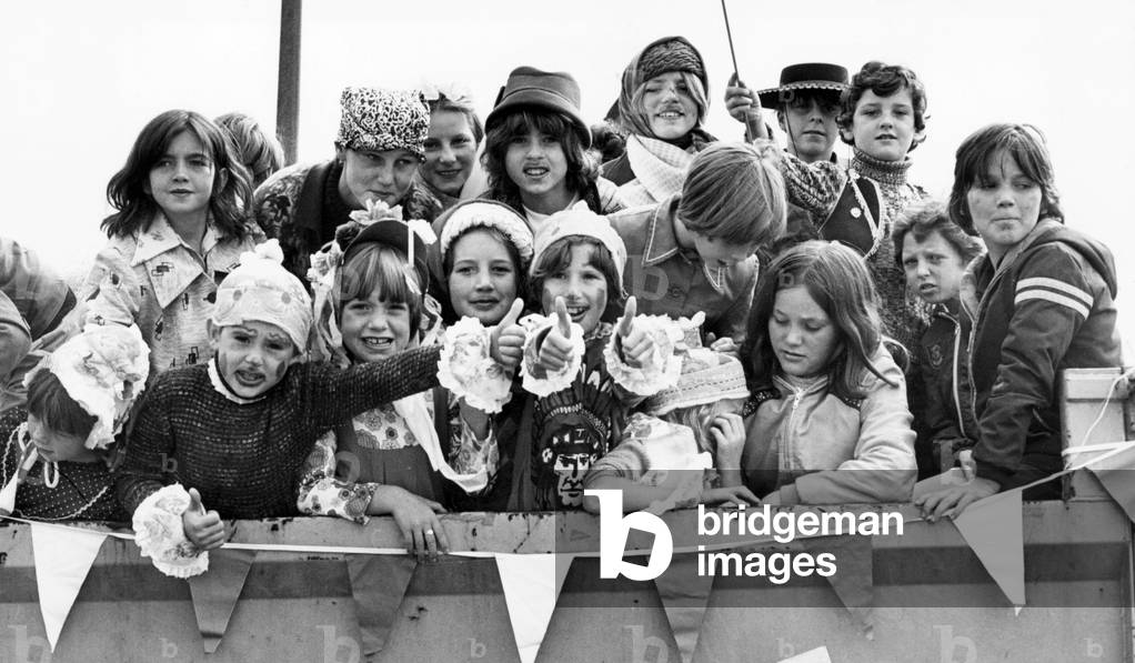 Kirkby's Westvale Estate is in carnival spirit this week for its first ever summer carnival. The festivities began when a colourful procession of 100 children in fancy dress paraded to the Copthorne Adventure Playground, followed by an afternoon of slideshows, competitions and discos. 23rd August 1977 (b/w photo)