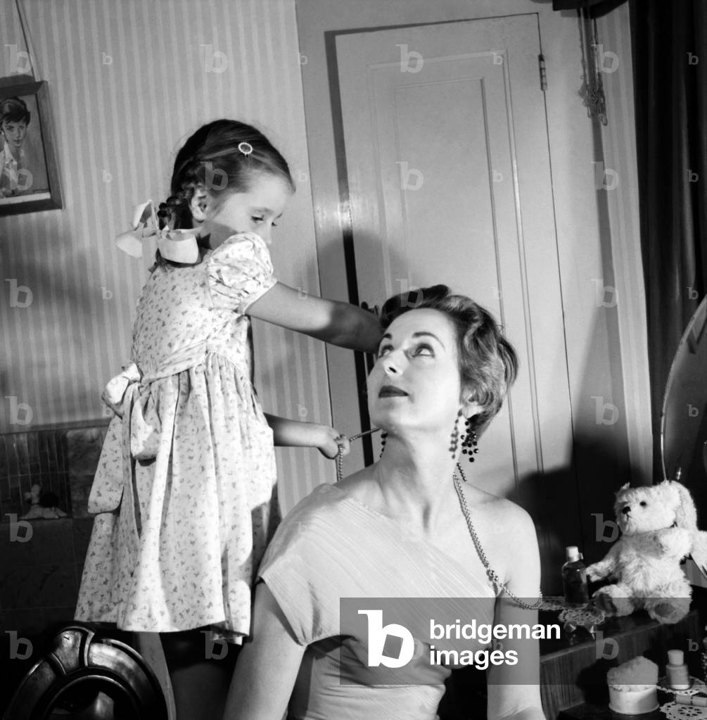 Woman and girl exercising Muriel Cordett and daughter Caroline (5) Muriel is to model spring fashions before Queen mother and Princes Margaret. November 1953
