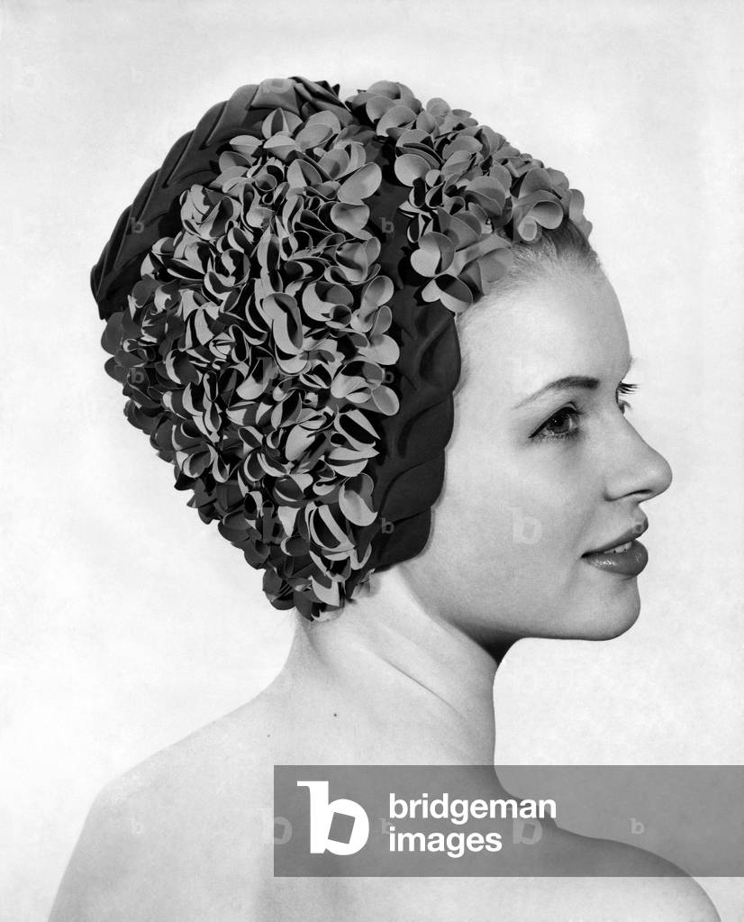 Clothing Beach: Cosy Posy. Clusters of tiny petals give this pillar box cap a festive look. Price 3 guineas. June 1965 P018014