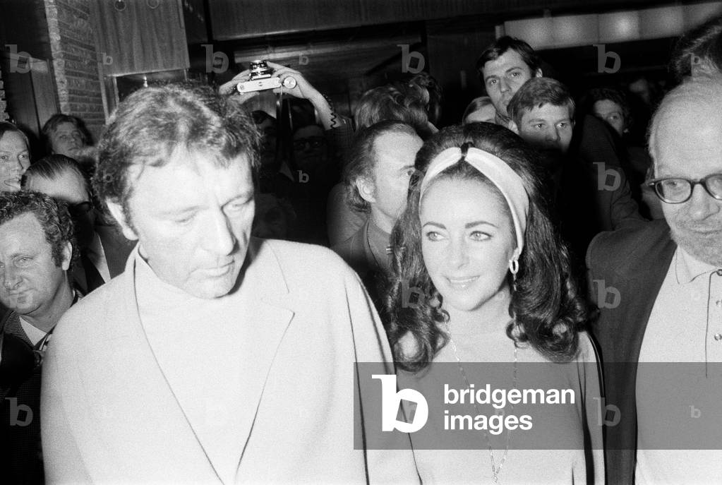 Richard Burton & Elizabeth Taylor, arrive for Liz Taylor's 40th Birthday Party, to be held at the International Hotel, Budapest, Hungary, Sunday 27th February 1972 (b/w photo)