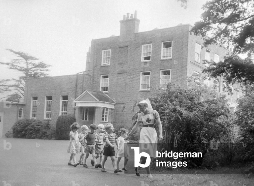 A nurse takses some children for a walk around the grounds of the Beech Hill House convalescent home. October 1958