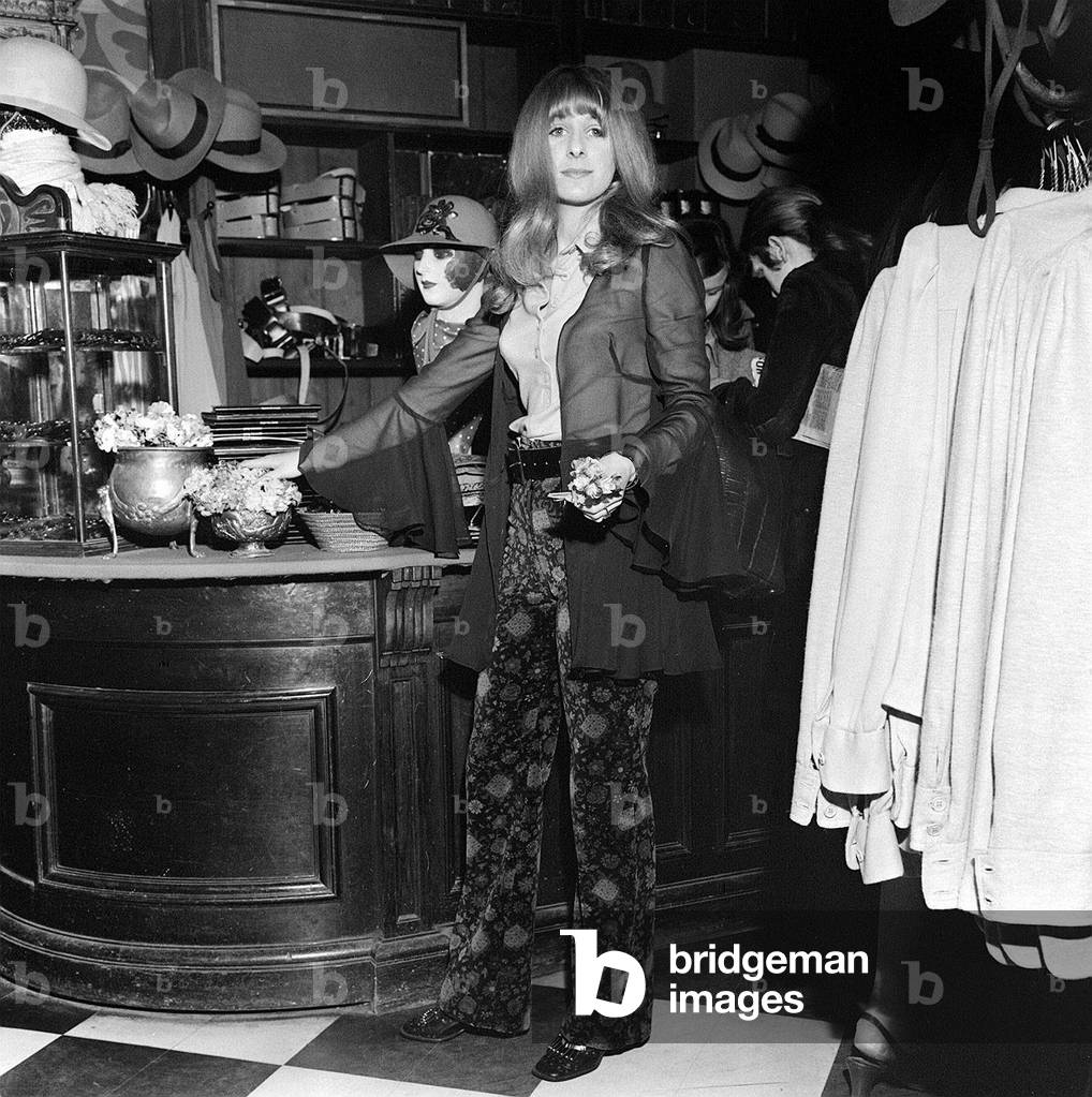 Boutique shop assistant Valerie Allen, 19, holding flowers in the BIBA shop, London, 28th March 1969 (b/w photo)