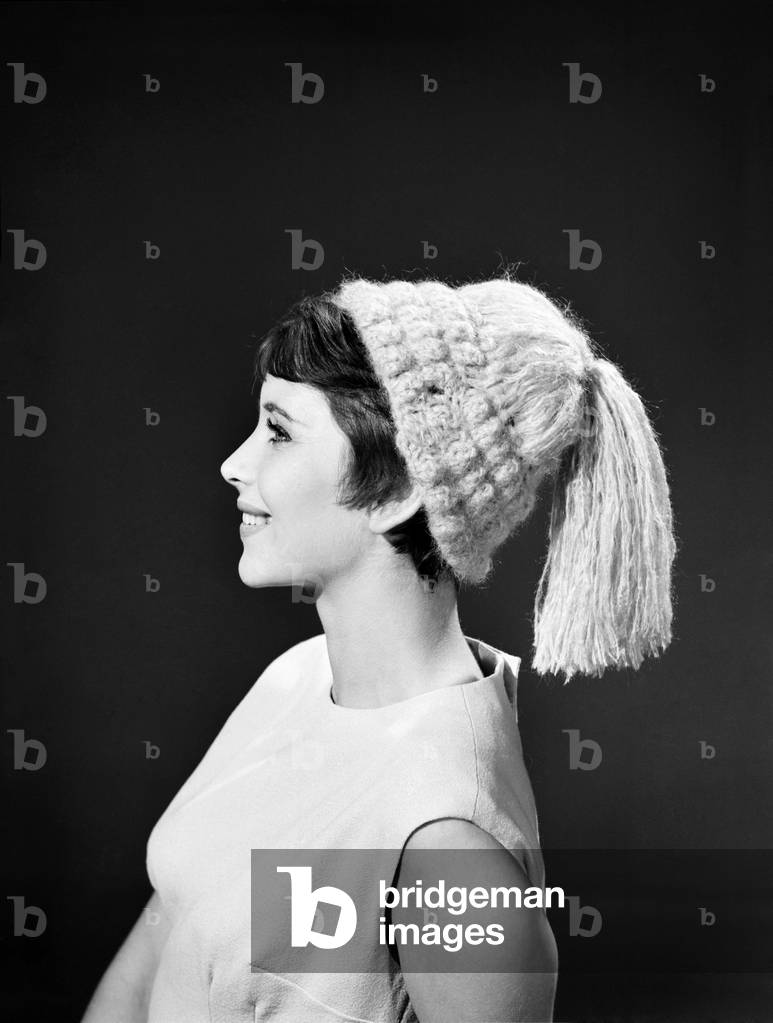 Model Ann Cave wearing knitted hat, c. 1960 (b/w photo)