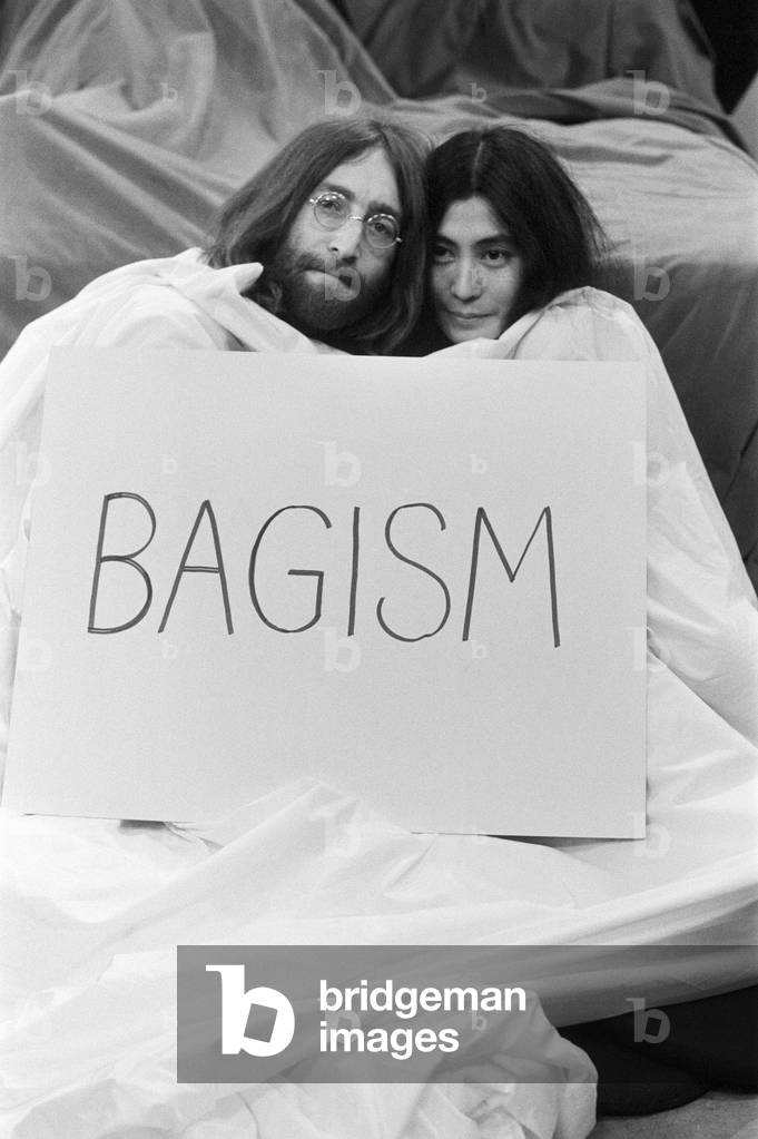 John Lennon and Yoko Ono appear on Thames Television's 'Today' programme with Eamonn Andrews. Eamonn started the programme in a bed and was joined by John and Yoko who emerged out of a bag at the bottom of the bed. 1st April 1969 (b/w photo)