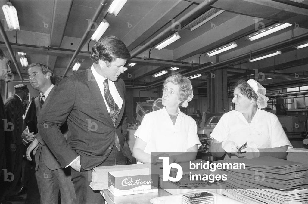 Senator Edward Kennedy seen here chatting to two of the Cadbury work force during his tour of the Cadbury Schweppes factory in Bournville. The Senator was in the Midlands as part of his five day tour of the UK. 13th September 1971 (b/w photo)