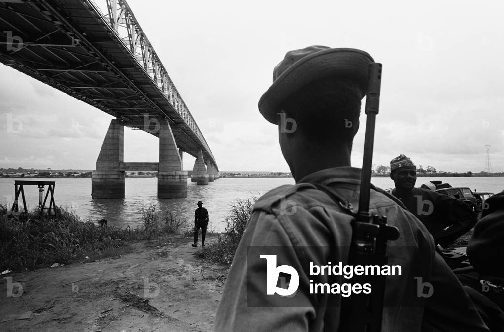 Pictures taken during the Daily Mirror's attempt to reach the refugee camps of Onitsha and Asaba during the Biafra conflict.
Picture shows a Nigerian federal soldier beside the Niger Bridge which was blown up at the Onitsha side.
16th July 1968.