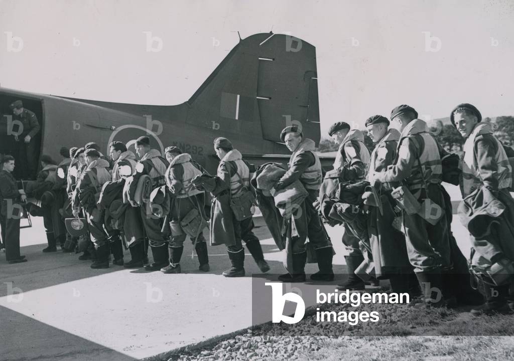 British Forces go to Far East theatre of war by air. Troops boarding a Transport command Dakota issued with Mae Wests and flying boots.
 29th June 1945