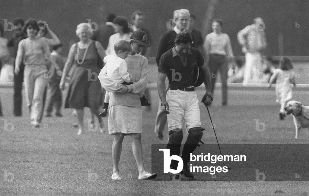Princess Diana with her husband Prince Charles and their youngest son Henry, known to all as Harry, at a polo match.
8th May 1988.