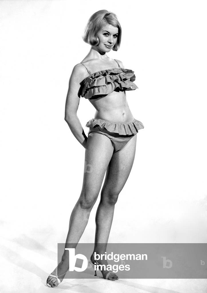 Model Vyoyan Dunbar wearing a frilly bikini outfit. 
July 1965