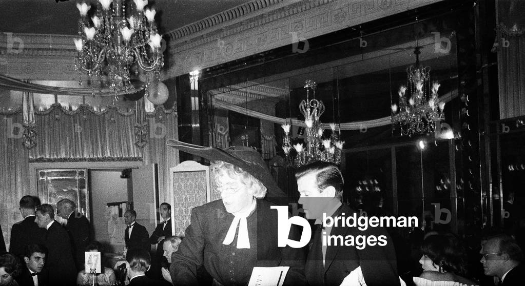 George Henry Hubert Lascelles, 7th Earl of Harewood, attends the Opera Ball at the Dorchester Hotel, Lord Harewood is dressed in a clergyman's outfit, February 1960 (b/w photo)