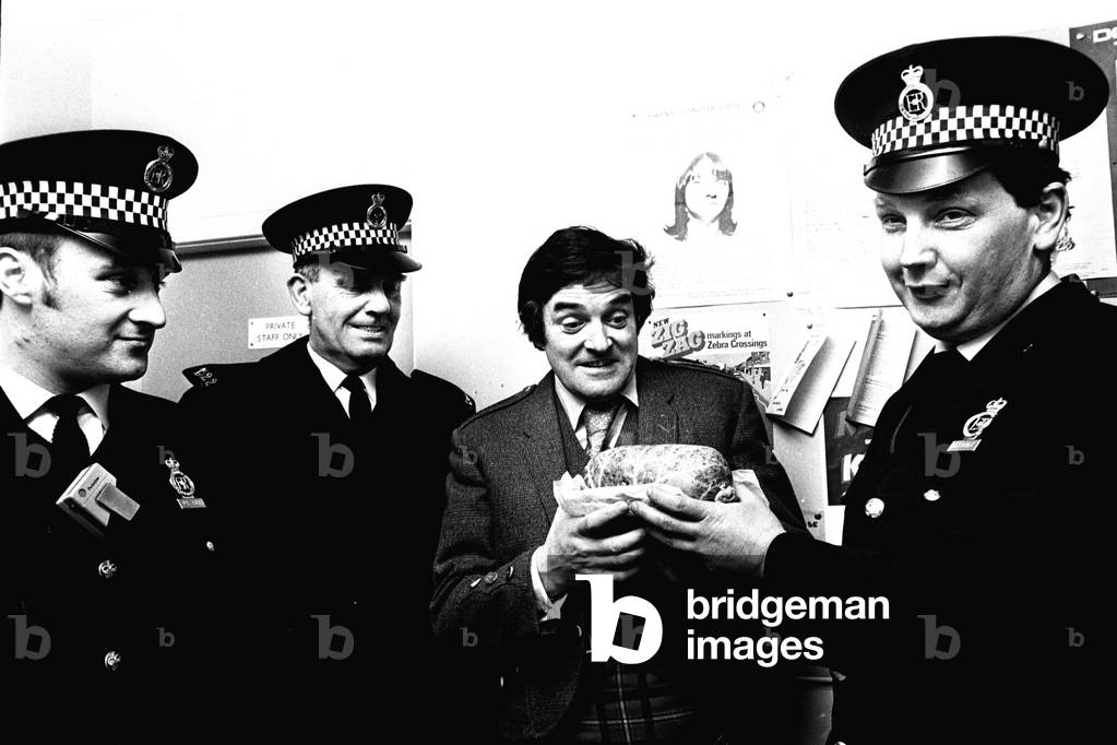 Comedian Jimmy Logan, who was in Newcastle appearing at Theatre Royal in The World of Jamie, collecting his haggis from Newcastle Central Police Station, pictured with Constable Bob Stephenson, left, and Sergent Linden Hutchinson 31/12/1971
