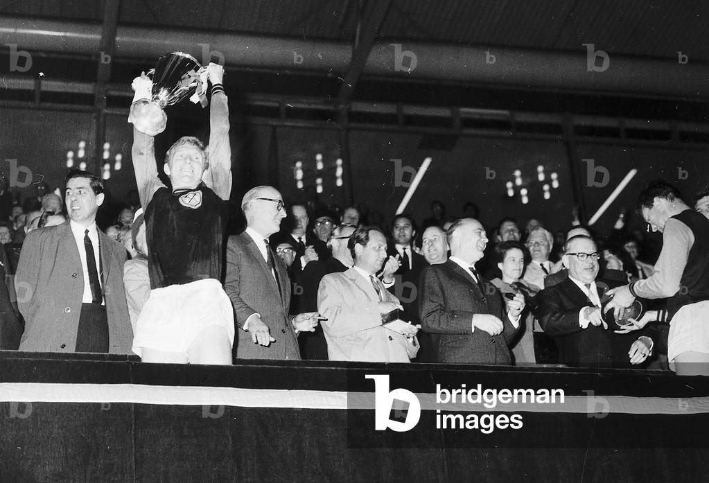 Bobby Moore of West Ham United holds cup aloft 1965after European Cup Winners Cup Final at Wembley (photo)