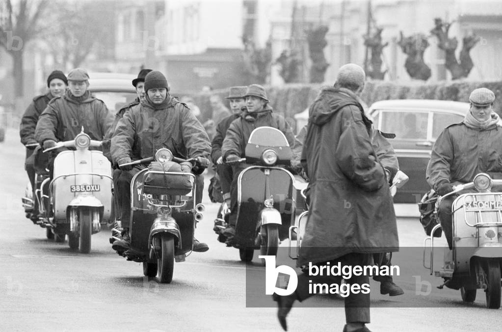 Mods on their scooters seen here driving along Clacton sea front. Over the 1964 Easter weekend several scuffles between Mods and Rockers broke out in the Essex seaside town. 30th March 1964 (b/w photo)