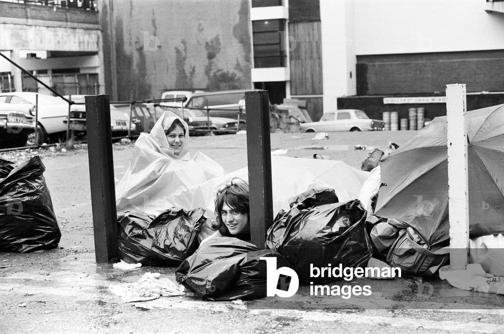 Fans queuing to see rock group The Who at Brighton, 1979 (b/w photo)