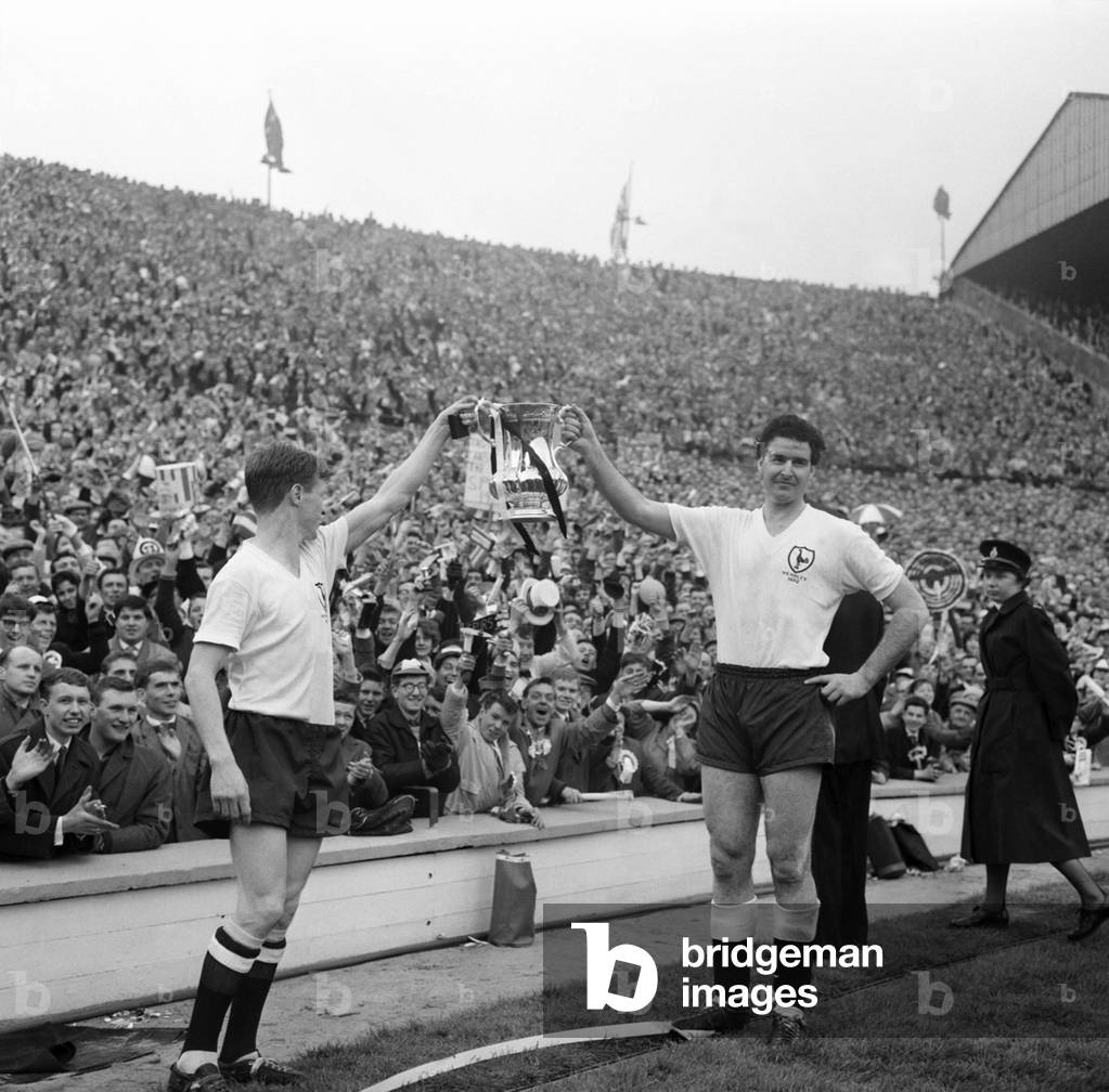 FA Cup final at Wembley Stadium. Tottenham Hotspur 3 v. Burnley 1. Maurice Norman of Spurs and teammate hold the trophy out for delighted fansMay 1962 Q3891-020 (photo)
