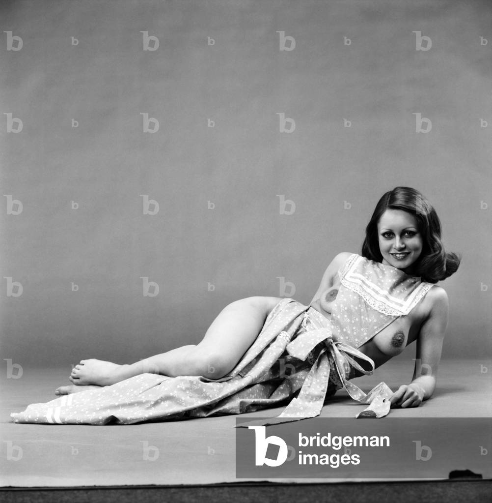 Glamour girl Geraldine June wearing a pinafore. 
January 1975