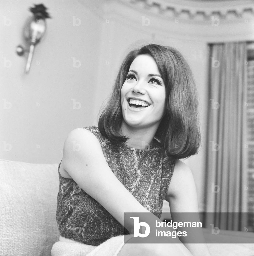 Parisienne actress Claudine Auger who will play Domino in the James Bond film Thunderball, seen here during an interview with the Daily Mirror show business reporter Donald Zec. 17th February 1965 (b/w photo)