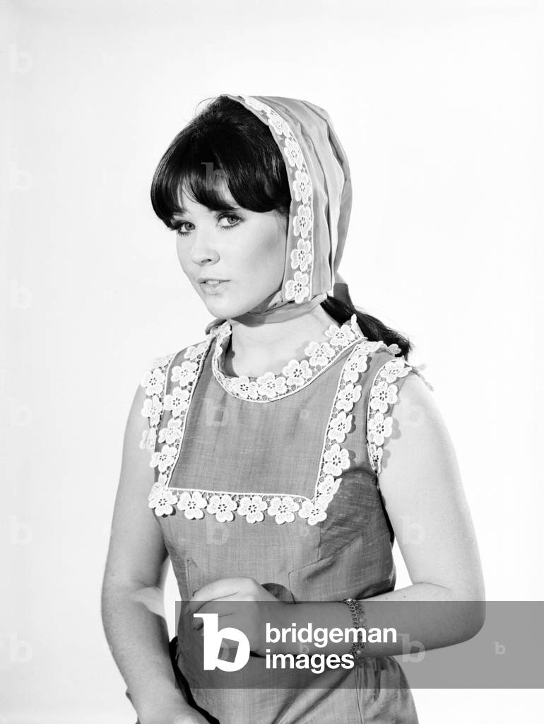 Clothing: Fashion: Hats: Woman wearing granny hood. Model: Rosemary Bell, 1966 (b/w photo)