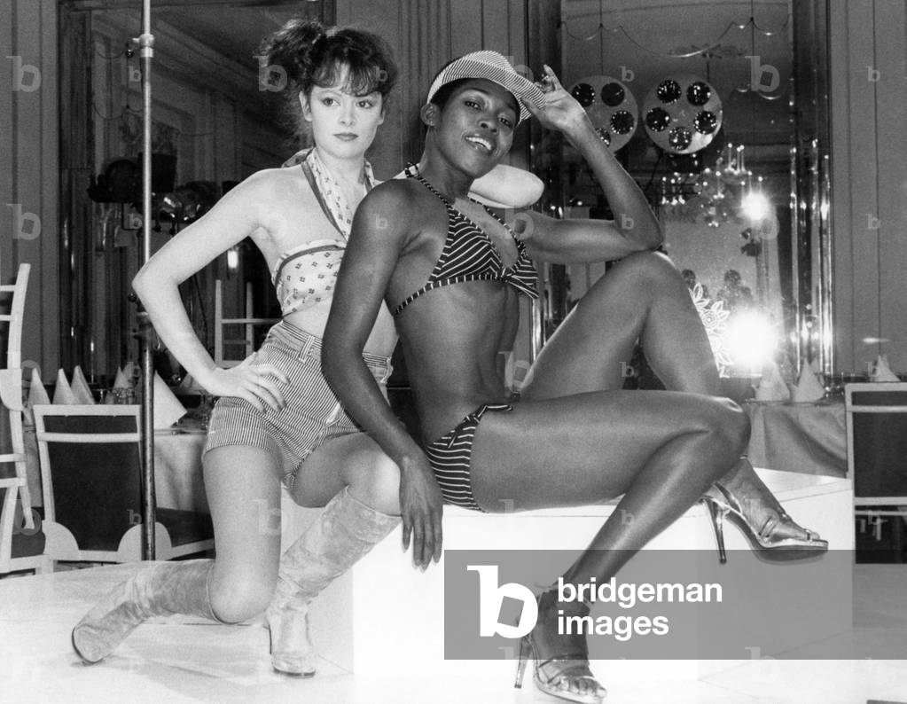 Clothing Beach. Kathy modelling a beach outfit in white and navy with drawstring waist and striped ticking shorts with Della Finch modelling a red and white striped Bikini. January 1978 P017923